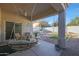 Inviting covered patio area features a swing, sitting area, and a view of the well-maintained backyard at 16546 E Ashbrook Dr # A, Fountain Hills, AZ 85268