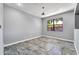 Bedroom with tile floors, neutral color paint, and a window at 17620 W Weatherby Dr, Surprise, AZ 85374