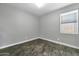 Cozy bedroom featuring tile floors, bright window and neutral paint at 17620 W Weatherby Dr, Surprise, AZ 85374