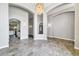 Elegant dining room featuring tile floors and a stunning chandelier, perfect for entertaining guests and Gathering dinners at 17620 W Weatherby Dr, Surprise, AZ 85374