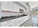 Sleek kitchen with dark countertops, white cabinets, and stainless steel appliances, offering a contemporary cooking experience at 17620 W Weatherby Dr, Surprise, AZ 85374