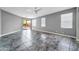 Bright living room featuring sliding door access to the backyard, neutral walls, and tile floors at 17620 W Weatherby Dr, Surprise, AZ 85374