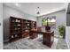 Home office featuring built-in shelving, work desk, large window providing natural light, and neutral wall paint at 17620 W Weatherby Dr, Surprise, AZ 85374