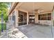 Covered patio featuring ceiling fan, outdoor seating area, and sliding glass doors that provide access to the home at 17620 W Weatherby Dr, Surprise, AZ 85374