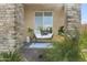 Inviting front porch featuring a cozy bench, decorative pillows, and stylish decor at 18465 W Fulton St, Goodyear, AZ 85338