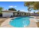 Swimming pool with a covered patio and an outdoor firepit surrounded by desert landscaping at 2136 W Sharon Ave, Phoenix, AZ 85029