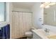 Bathroom featuring a shower with curtain, a toilet, a sink and a large mirror at 2136 W Sharon Ave, Phoenix, AZ 85029