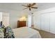 Bedroom featuring a ceiling fan, dresser, closet, and an adjoining bathroom at 2136 W Sharon Ave, Phoenix, AZ 85029