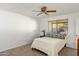 Bright bedroom with large window, ceiling fan and neutral carpet at 2136 W Sharon Ave, Phoenix, AZ 85029