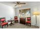 Bedroom with hardwood floors, ceiling fan, large windows, chairs and side table at 2136 W Sharon Ave, Phoenix, AZ 85029