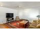 Comfortable living room featuring a ceiling fan, plush seating, and a large area rug at 2136 W Sharon Ave, Phoenix, AZ 85029