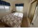 Bedroom with wooden floors, mirrored closet, and blue curtains at 2315 S Seminole Dr, Apache Junction, AZ 85119