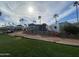 The home has a covered patio, palm trees and is situated near a landscaped area and golf carts at 2315 S Seminole Dr, Apache Junction, AZ 85119