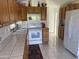 Spacious kitchen boasts ample counter space, white appliances, and wooden cabinets at 2315 S Seminole Dr, Apache Junction, AZ 85119