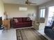 Comfortable living room with a red sofa, sitting chairs, and sliding glass doors leading to the outside patio at 2315 S Seminole Dr, Apache Junction, AZ 85119