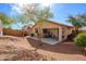 The large backyard features a covered patio, desert landscaping, and privacy wall at 23836 W Jefferson St, Buckeye, AZ 85396