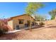 Spacious backyard featuring desert landscaping, privacy wall, and a covered patio at 23836 W Jefferson St, Buckeye, AZ 85396