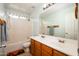 Well-lit bathroom with a double sink vanity, large mirror, and a shower-tub combination at 23836 W Jefferson St, Buckeye, AZ 85396