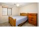 Comfortable bedroom featuring a light wood bed frame and matching dresser at 23836 W Jefferson St, Buckeye, AZ 85396