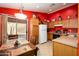 Dining area with a table set for a meal, bright lighting, and convenient access to the kitchen at 23836 W Jefferson St, Buckeye, AZ 85396