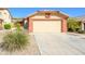 Two car garage with wide driveway and low maintenance front yard landscaping at 23836 W Jefferson St, Buckeye, AZ 85396