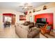 Open living room with a comfortable sofa, bright walls, and a view into the dining area at 23836 W Jefferson St, Buckeye, AZ 85396