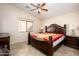 Comfortable main bedroom featuring a large bed, ceiling fan, and neutral decor at 23836 W Jefferson St, Buckeye, AZ 85396