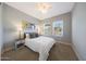 Cozy bedroom with neutral walls, featuring a ceiling fan and three decorative art pieces above the bed at 240 W Missouri Ave # 13, Phoenix, AZ 85013