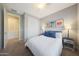 Bright bedroom with a closet and modern decor featuring a queen bed with stylish gray pillows at 240 W Missouri Ave # 13, Phoenix, AZ 85013