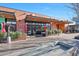 Restaurant exterior with brick accents, outdoor seating, and modern design elements at 240 W Missouri Ave # 13, Phoenix, AZ 85013