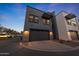 Modern townhouse featuring an attached garage, contemporary design, and beautiful landscaping at 240 W Missouri Ave # 13, Phoenix, AZ 85013