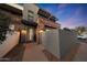 Modern townhome with a brick and stucco exterior, featuring a private entrance and well-maintained landscaping at 240 W Missouri Ave # 13, Phoenix, AZ 85013