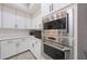 Stylish kitchen with stainless steel appliances, white cabinets, and sleek countertops at 240 W Missouri Ave # 13, Phoenix, AZ 85013