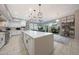 Spacious kitchen featuring white cabinetry, a large island with seating, and modern appliances at 240 W Missouri Ave # 13, Phoenix, AZ 85013