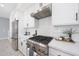 Modern kitchen with stainless steel appliances, white cabinetry, subway tile backsplash, and professional-grade gas range at 240 W Missouri Ave # 13, Phoenix, AZ 85013