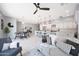 Bright living room with open floor plan, ceiling fan, modern decor, and a view of the kitchen at 240 W Missouri Ave # 13, Phoenix, AZ 85013