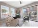 Cozy living room with two windows and a sliding glass door, with outside view to outdoor patio at 240 W Missouri Ave # 13, Phoenix, AZ 85013
