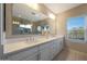 Well-lit main bathroom featuring double sinks, quartz countertops, and walk-in shower at 240 W Missouri Ave # 13, Phoenix, AZ 85013