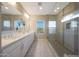 Modern main bathroom featuring double sinks, quartz countertops, a large mirror, and walk-in shower at 240 W Missouri Ave # 13, Phoenix, AZ 85013