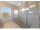 Glass enclosed main shower with tile surround, a window, and built-in bench at 240 W Missouri Ave # 13, Phoenix, AZ 85013