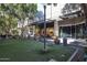 Exterior shot of a landscaped green courtyard lined with stores at 240 W Missouri Ave # 13, Phoenix, AZ 85013