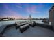 Relaxing rooftop with gray wicker sofa, ottoman, and beautiful city views at 240 W Missouri Ave # 13, Phoenix, AZ 85013