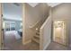 Carpeted staircase leading to an upstairs bedroom featuring a light color palette and natural light at 240 W Missouri Ave # 13, Phoenix, AZ 85013