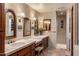 Elegant bathroom with double vanities, wood cabinets, and tiled walls and flooring at 25002 N Quail Haven Dr, Rio Verde, AZ 85263