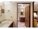 Bathroom entryway featuring tile flooring, wood vanity and door, and cream walls at 25002 N Quail Haven Dr, Rio Verde, AZ 85263