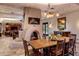 Open concept dining room featuring fireplace, rustic furnishings, and natural light at 25002 N Quail Haven Dr, Rio Verde, AZ 85263