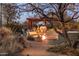 Backyard oasis with a stone fire pit, inviting desert landscaping, and a pergola for enjoyable outdoor gatherings at 25002 N Quail Haven Dr, Rio Verde, AZ 85263