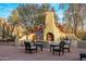 Outdoor fireplace with ample seating, perfect for entertaining friends and Gathering at 25002 N Quail Haven Dr, Rio Verde, AZ 85263