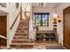 Bright foyer with tiled stairs, wooden railing, natural light, and decorative accents adding character at 25002 N Quail Haven Dr, Rio Verde, AZ 85263