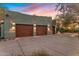 Wide shot of the garages featuring wooden doors and lights along the top, and a concrete driveway at 25002 N Quail Haven Dr, Rio Verde, AZ 85263